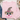 A light pink crewneck sweatshirt laid flat on a white wood background, featuring a cute scarecrow face graphic with a leopard-print witch hat, pink flower, and pink stitched smile. Styled flat-lay props include blue jeans, a mug, and small greenery.