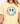 Person wearing a yellow t-shirt with a smiley face design featuring flowers on a plain background