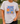 Person wearing a t-shirt with 'Jesus Loves Softball' design on a baseball field.