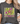 Person wearing a dark gray t-shirt with a colorful starfish design and text.