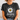 Person wearing a black t-shirt with a daisy graphic and text.