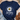 Navy blue t-shirt with a daisy graphic and text on a textured surface with jeans and sandals.