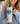 Person holding a tumbler with a dog-themed design and text.