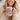 Woman holding a pink mug with a motivational quote, smiling.
