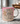 Pink mug with motivational quote and cross design on a marble surface