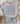Gray t-shirt with 'USA' text design on a light surface with decorative items.