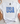 White t-shirt with 'USA' text in blue stars on a light surface with decorative items.